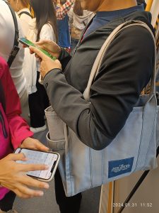 People looking at their smartphones while travelling on a train.