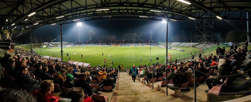 Streaming’s Next War Is Over Sports Rights, Not Shows A packed stadium under floodlights during a night match